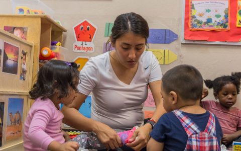 child putting on shoe